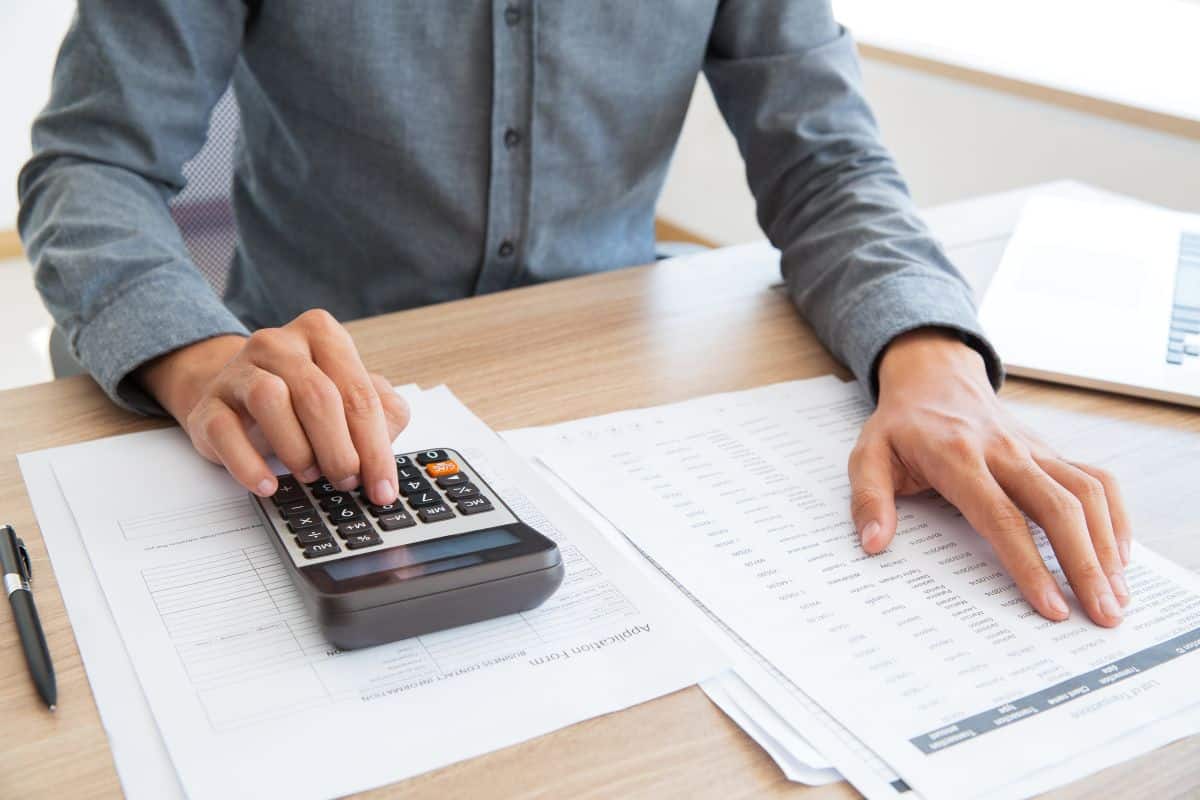 accountant calculating income and examining report